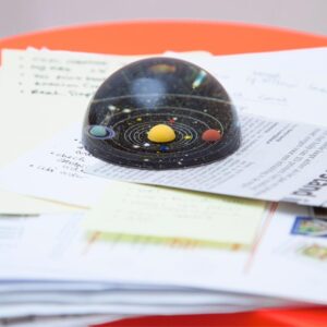 Planetary Solar System paperweight on desk