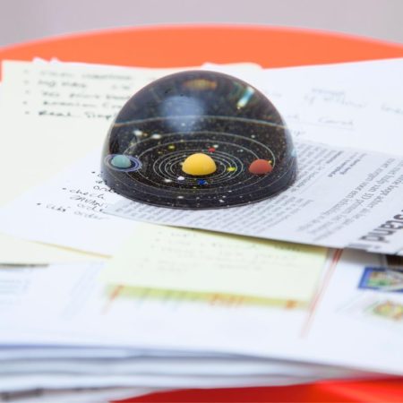 planetary solar system paperweight on desk