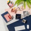 Poketo vegan leather desk mats shown in pink and grey shades side by side