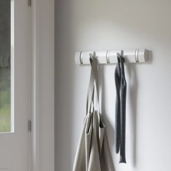 White wall mounted hook rack, mounted in entryway