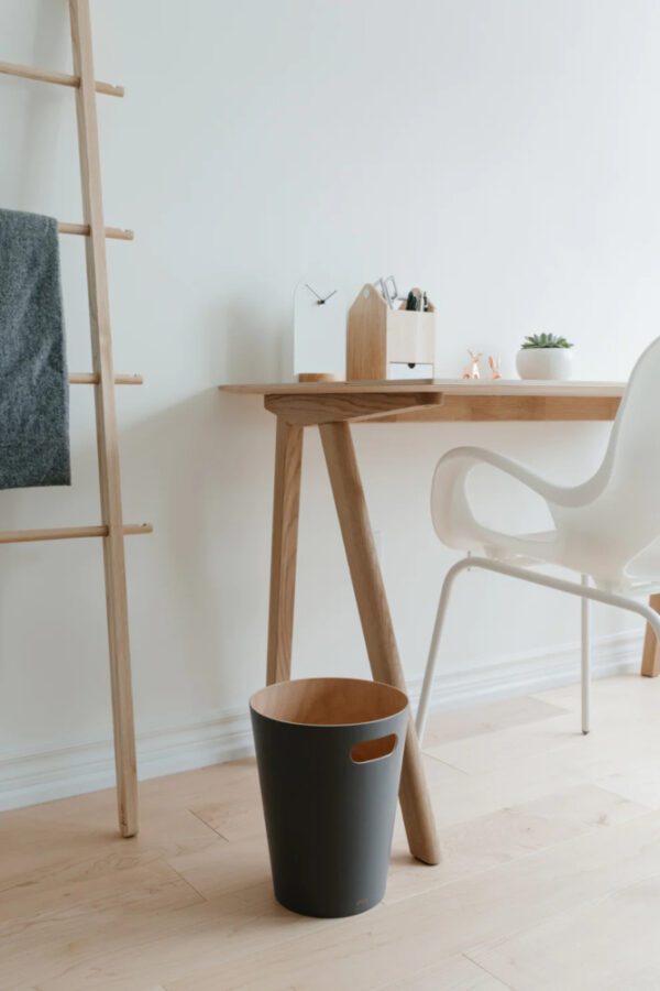 Grey Woodrow trash can shown next to wooden desk